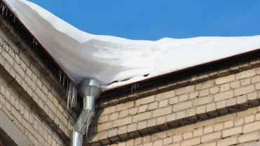 Dak vol met sneeuw – Gebouwenverzekering – Zakelijk