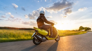 Motor,Biker,Riding,On,Empty,Road,With,Sunset,Light,,Concept