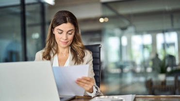 Busy,Mid,Aged,Business,Woman,Working,In,Office,With,Laptop