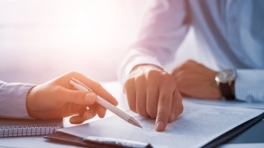 Business,People,Negotiating,A,Contract.,Human,Hands,Working,With,Documents