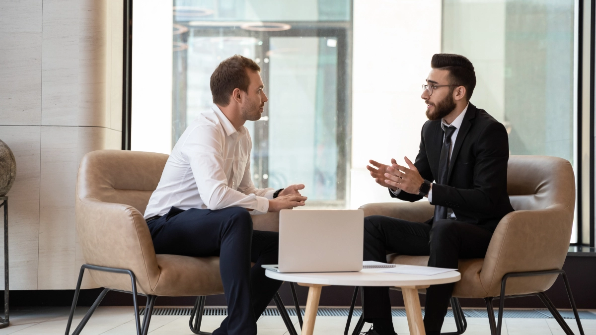 Middle,Eastern,And,Caucasian,Ethnicity,Businessmen,Seated,On,Armchair,In