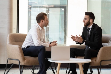 Middle,Eastern,And,Caucasian,Ethnicity,Businessmen,Seated,On,Armchair,In