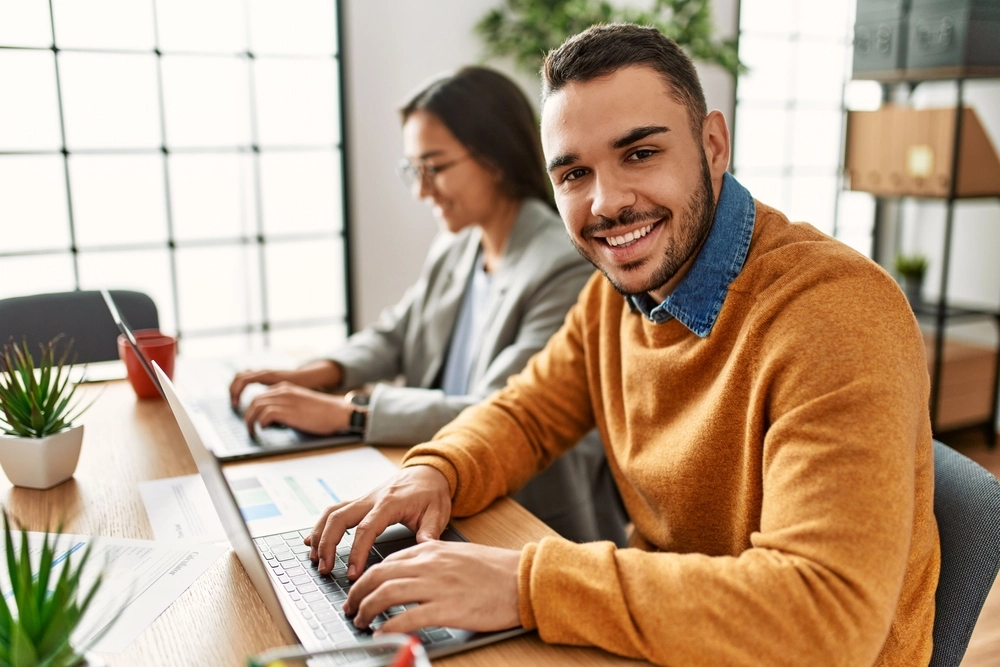 Two,Business,Workers,Smiling,Happy,Working,Sitting,On,Desk,At