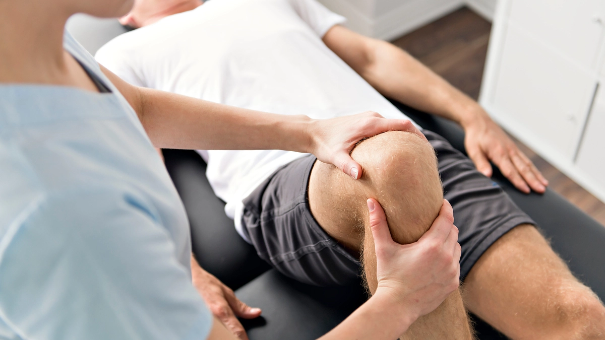 Patient at the physiotherapy doing physical exercises with his therapist